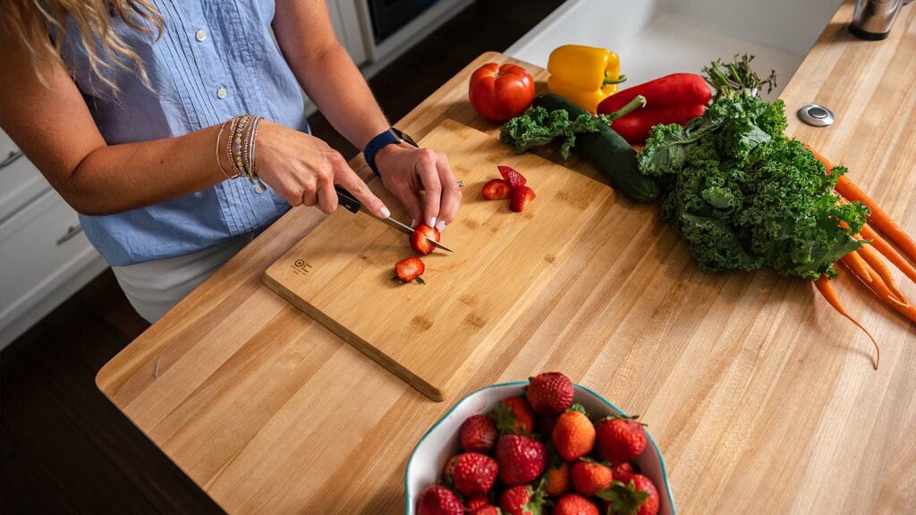 Woman cutting up strawberries