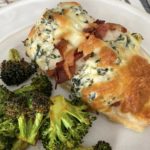 Baked chicken breast stuffed with a cream cheese and spinach mixture, topped with melted mozzarella cheese with a side of roasted broccoli