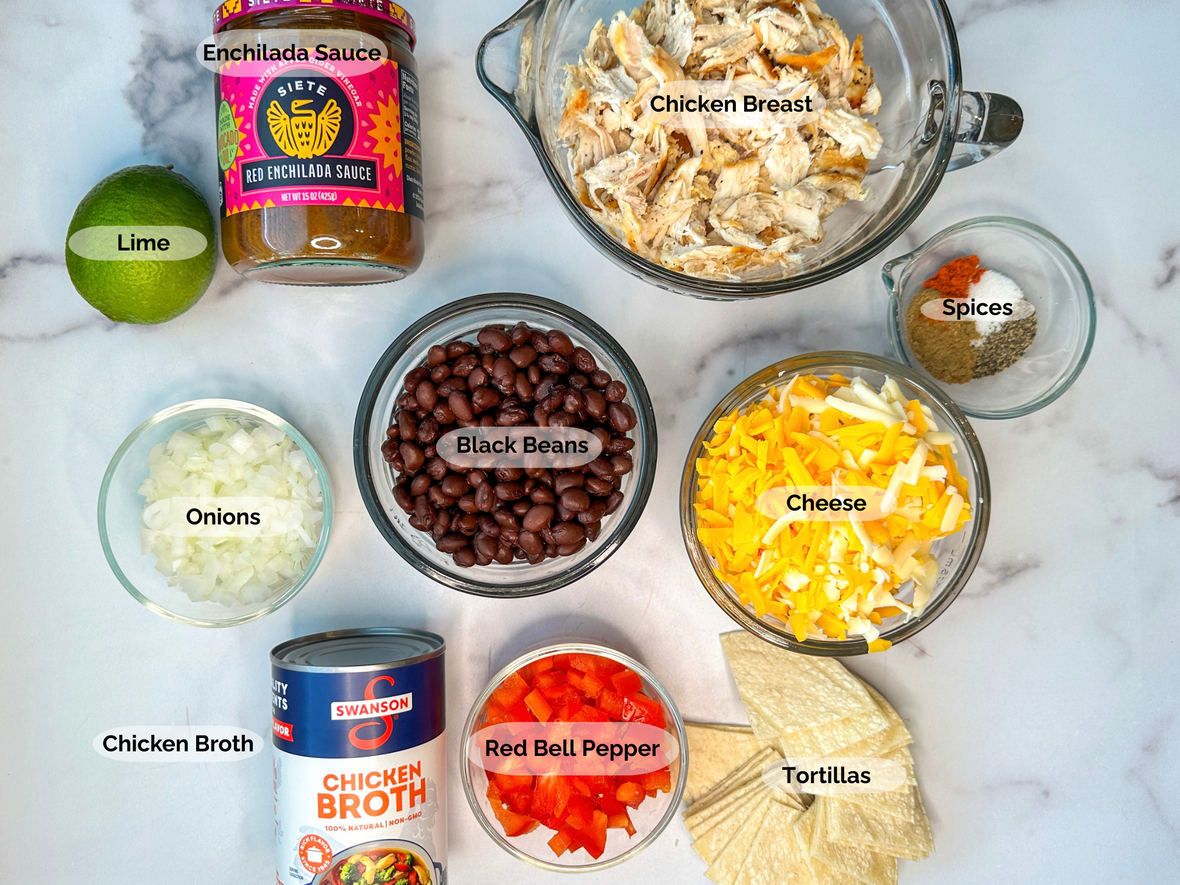 Chicken Enchilada Skillet Ingredients: lime, enchilada sauce, shredded chicken breasts, spices, shredded cheese, black beans, chopped onions, chicken broth, diced red bell peppers, quartered tortillas.