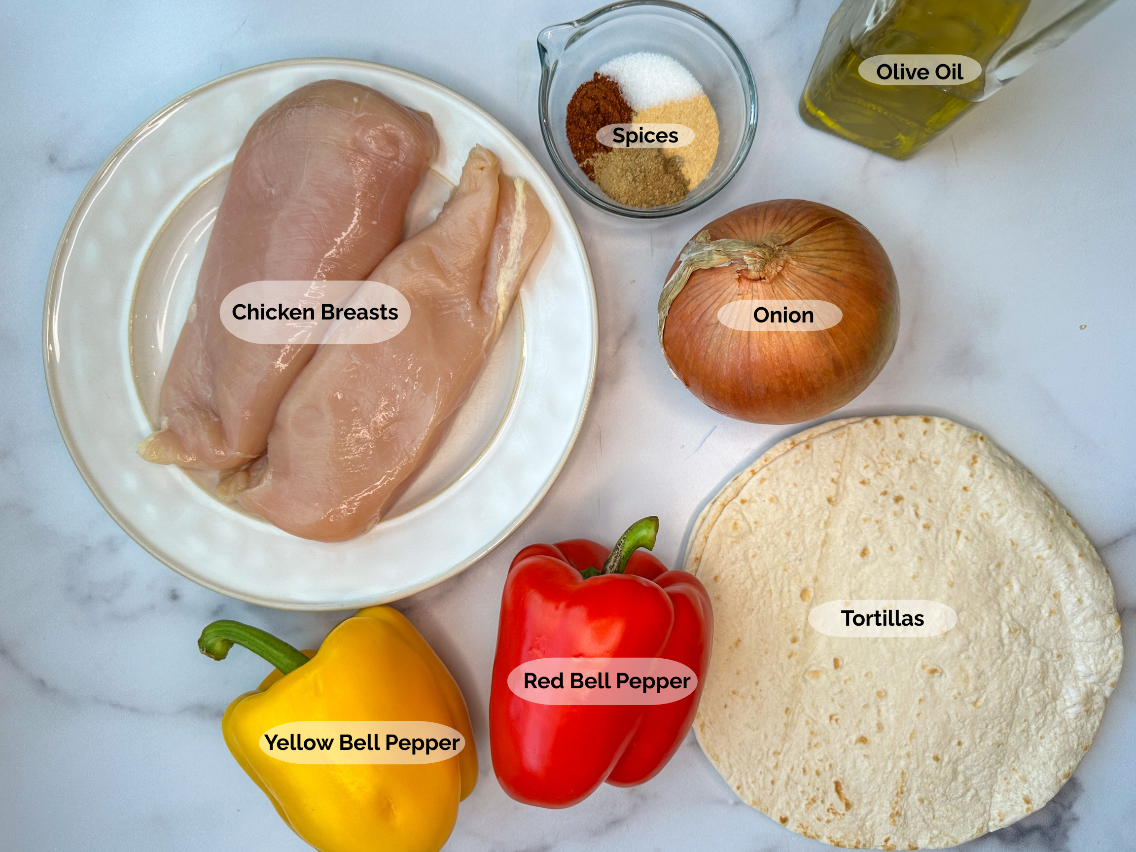 Sheet Pan Fajita ingredients: 2 Chicken breasts, spices, olive oil, onion, tortillas, red bell pepper and yellow bell pepper.