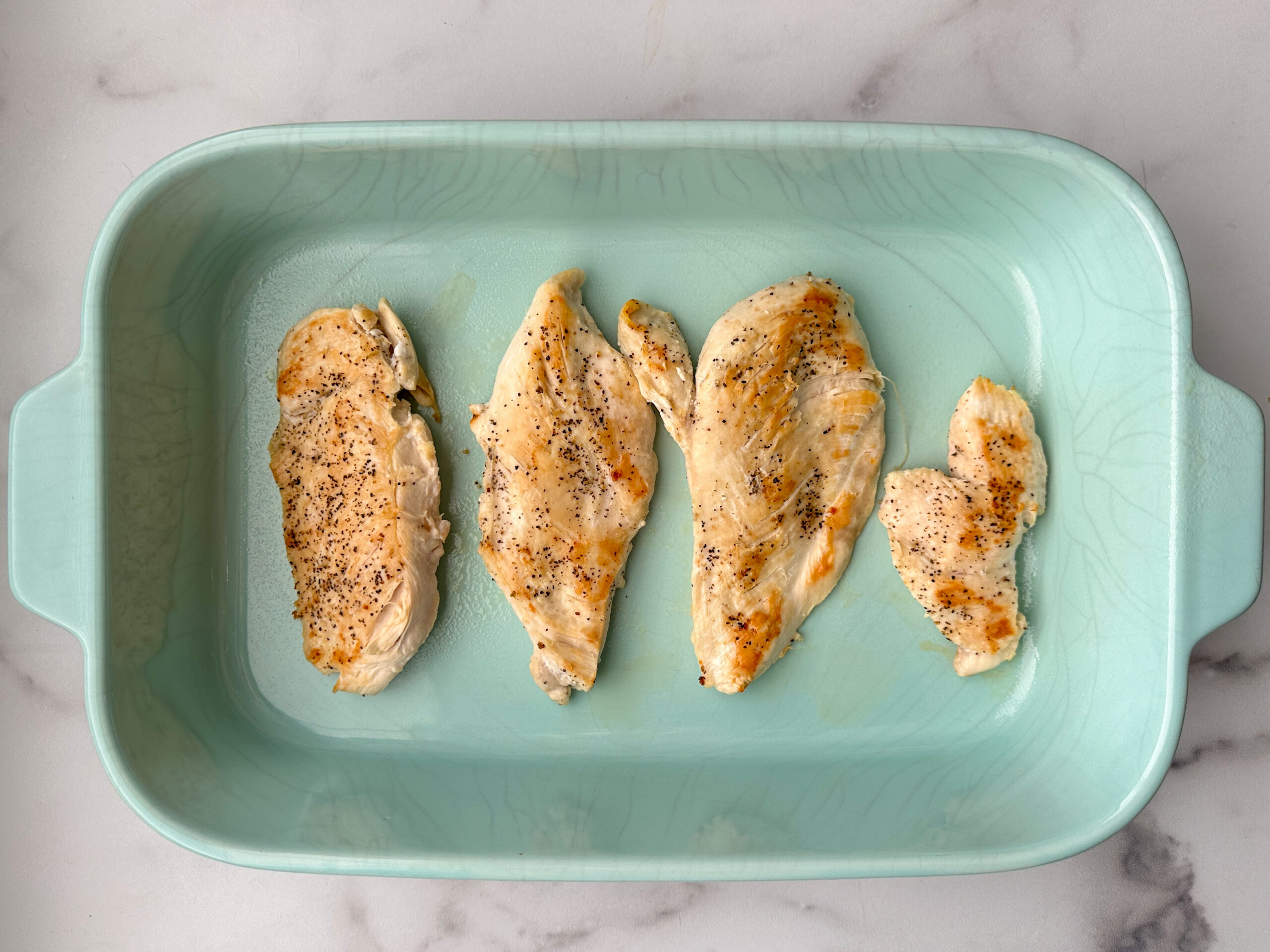 4 thinly sliced chicken breasts that have been grilled and placed in 9x13 baking dish.