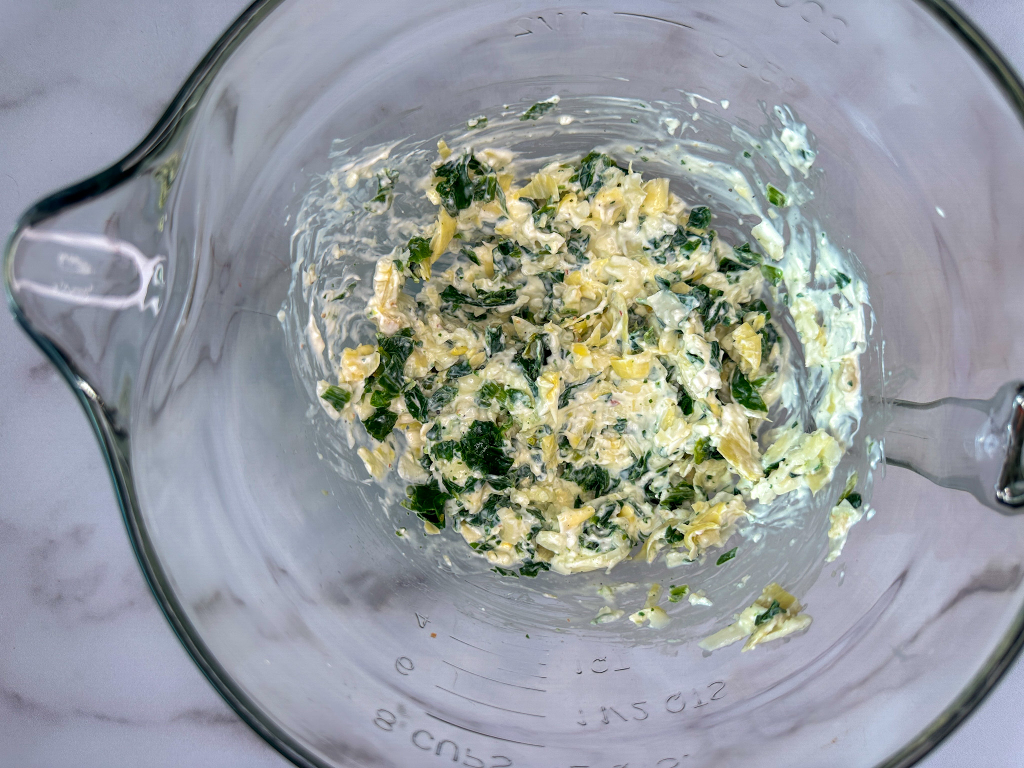 cream cheese and chopped spinach mixture in a mixing bowl