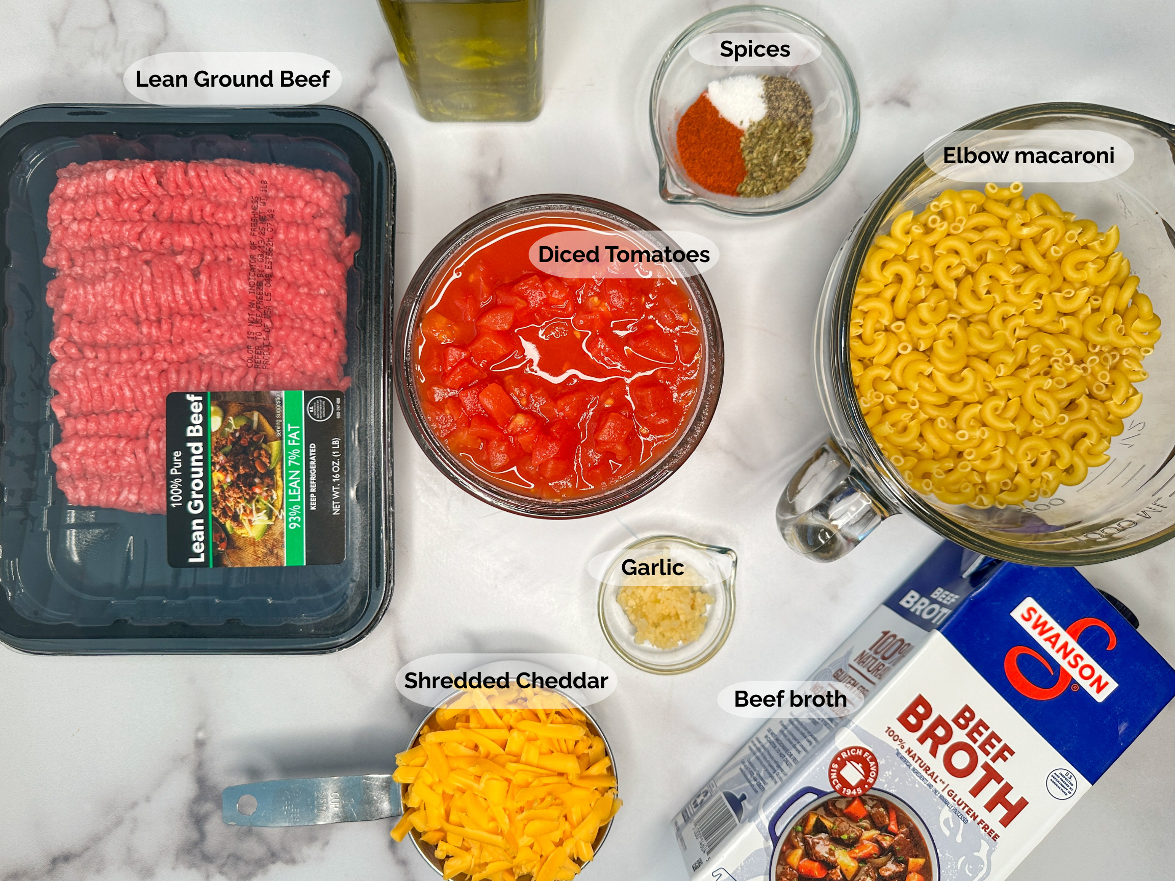 Healthier Hamburger Helper Ingredients: lean ground beef, diced tomatoes, spices, uncooked elbow macaroni, minced garlic, shredded cheddar cheese, and beef broth