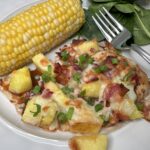Chicken breast covered in pineapple, bbq sauce, mozzarella cheese, and green onions