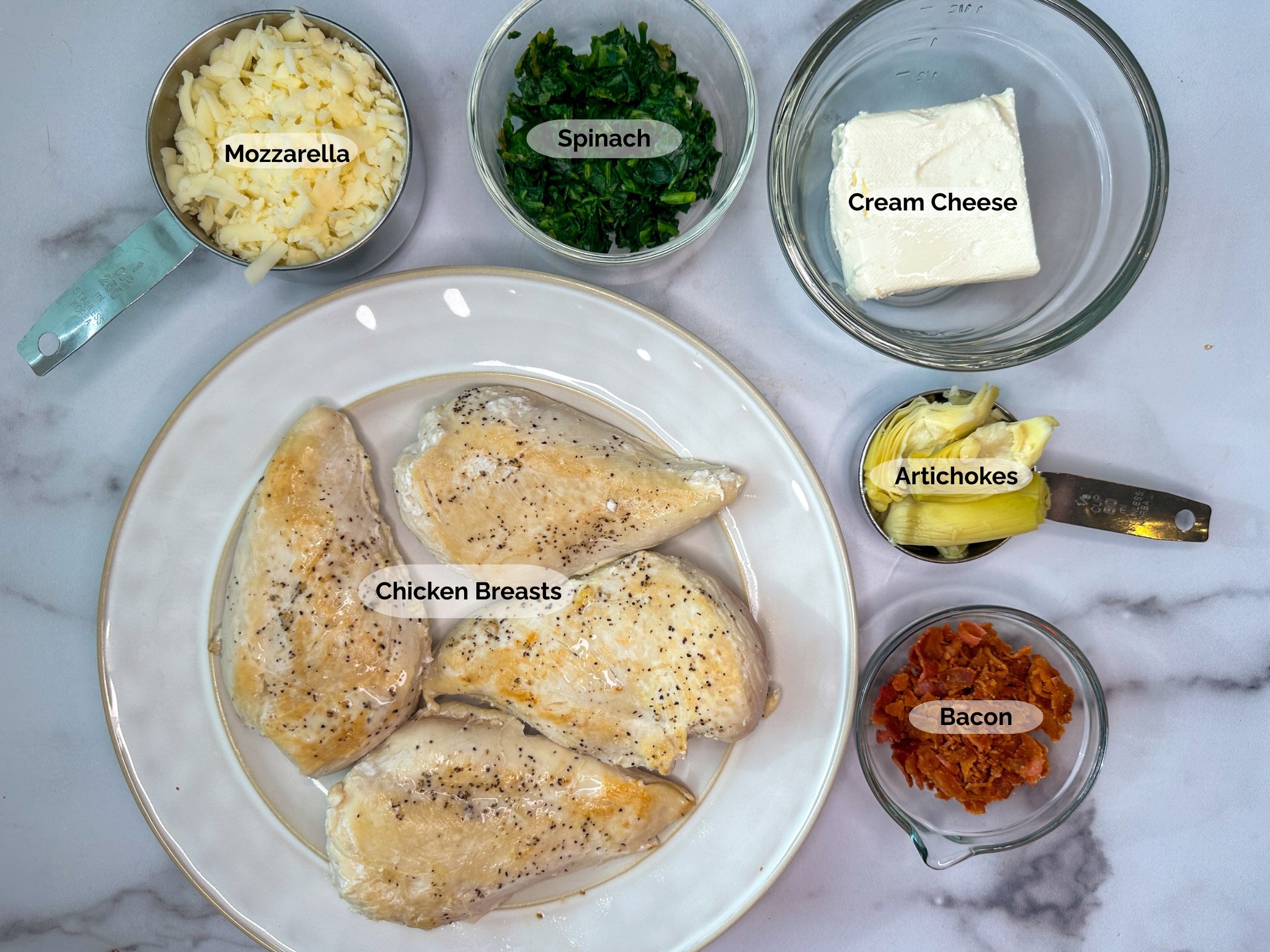 Spinach & Bacon Stuffed Chicken Breasts ingredients: 4 boneless skinless chicken breasts, shredded mozzarella, chopped spinach, cream cheese, artichokes, and crumbled bacon.