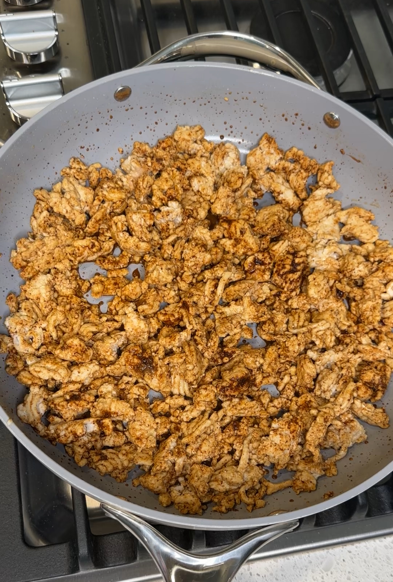 Cooked lean ground turkey with spices in a skillet