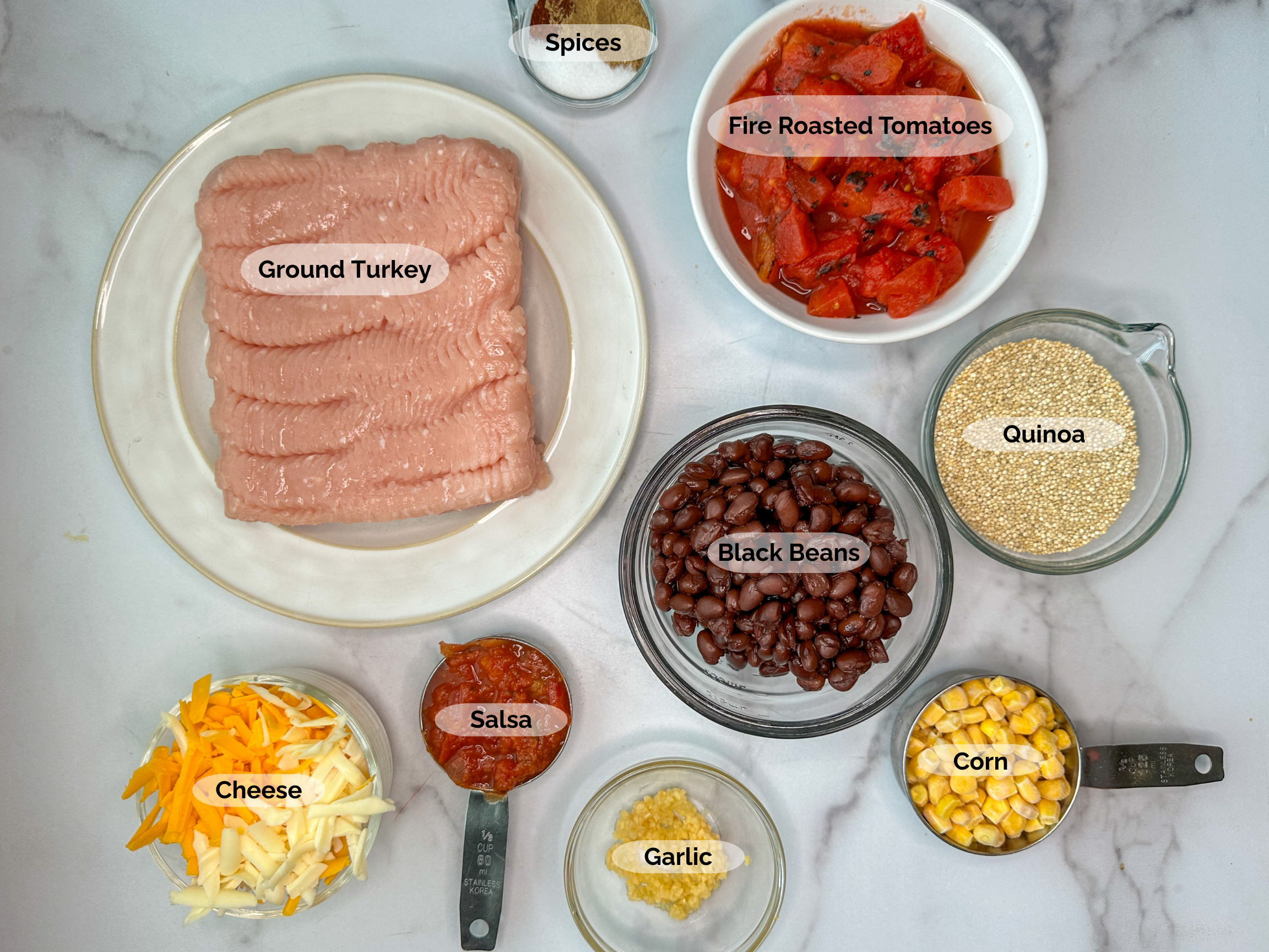 Turkey Taco Quinoa ingredients: lean ground turkey, spices, fire roasted tomatoes, quinoa, black beans, corn, salsa, garlic, and cheese.