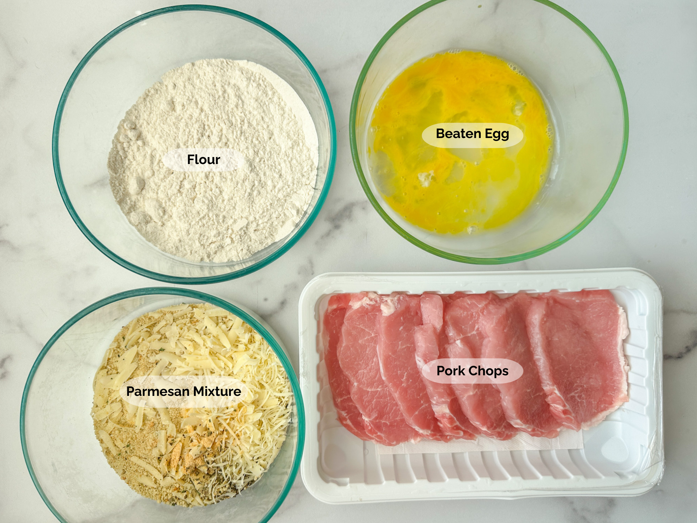 Crispy Parmesan Pork Chops ingredients: flour, beaten egg, 5 pork chops, parmesan mixture of parmesan cheese, spices, and breadcrumbs.