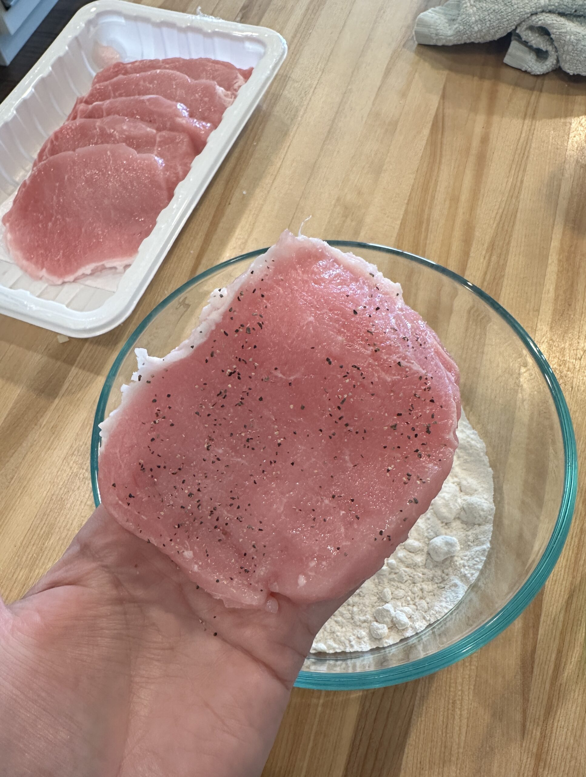 pork chop getting ready to be floured.