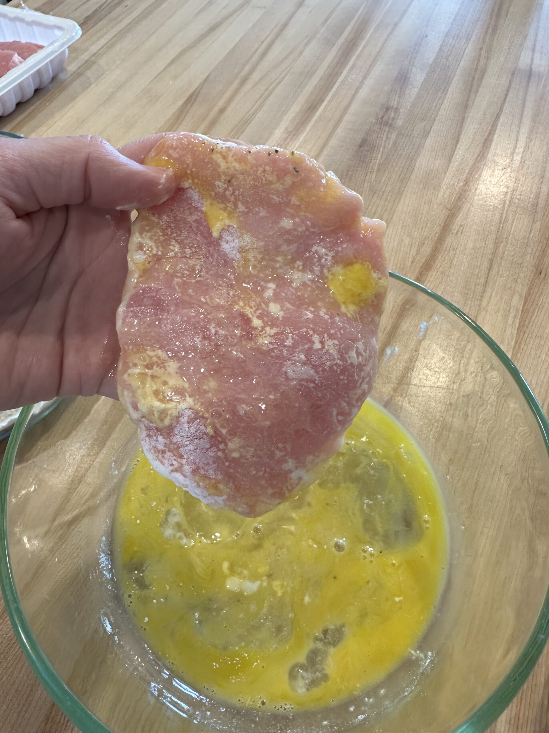 floured pork chop dunked in egg wash.