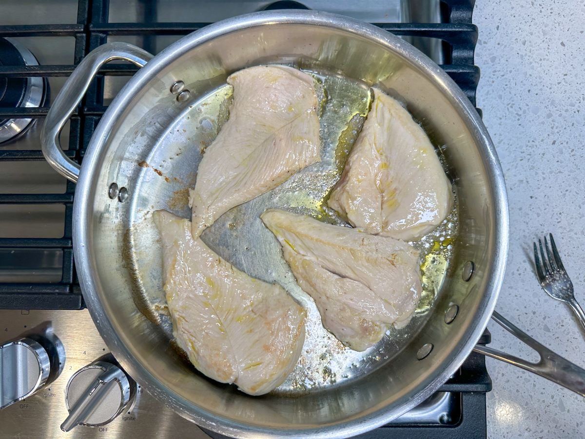 4 thinly sliced grilled chicken breasts in a large skillet.