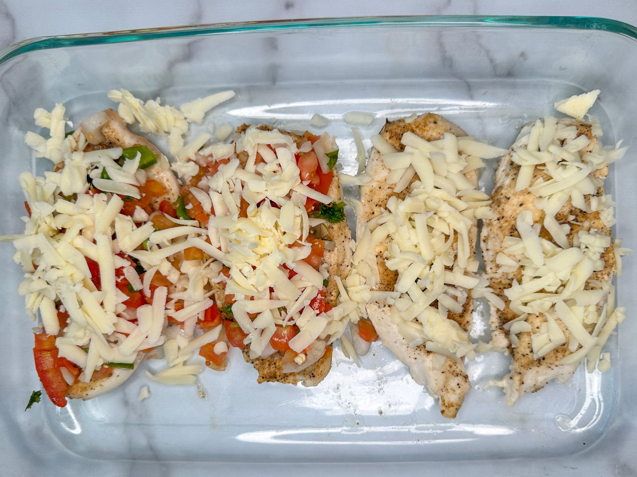 4 chicken breasts in a 9x13 baking dish with pico de gallo on top followed by shredded monterey jack cheese.