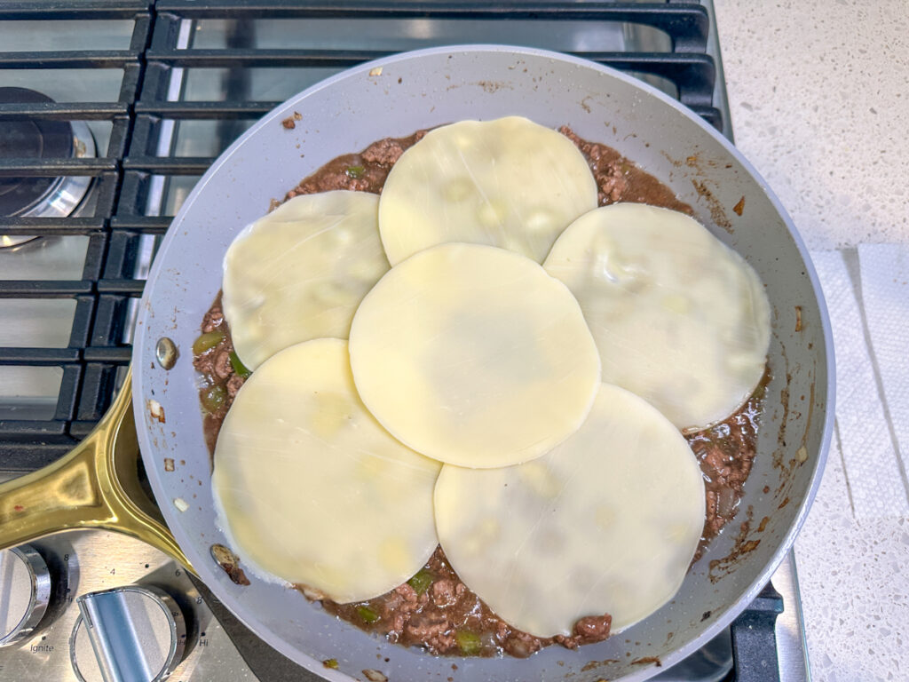 6 slices of provolone cheese on top of ground beef for philly cheesesteak sloppy joes.