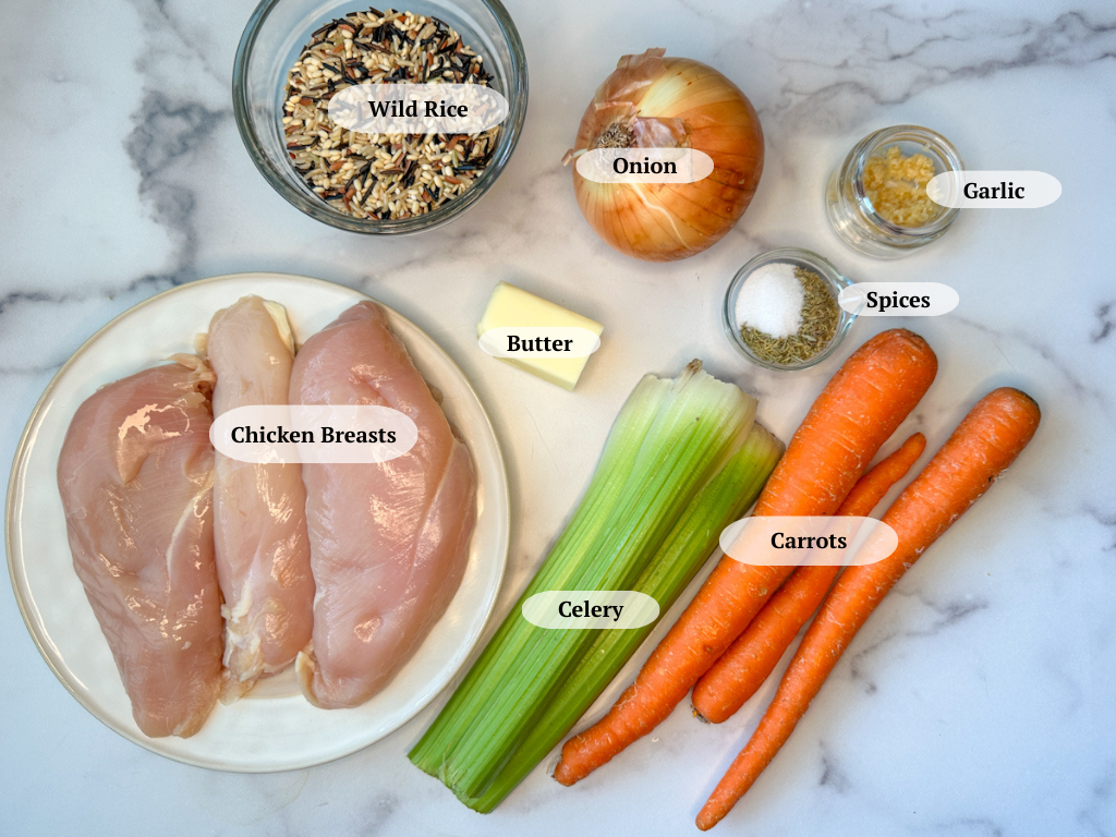 Chicken & Wild Rice Soup ingredients: chicken breasts, wild rice, butter, celery sticks, carrots, spices, an onion, and minced garlic