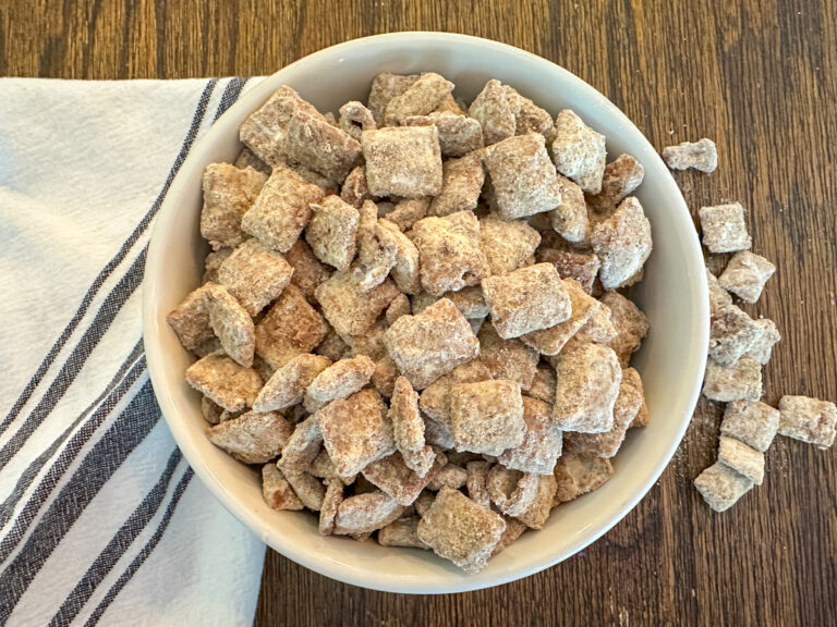 Protein puppy chow in a bowl with a white and blue striped napkin beside it