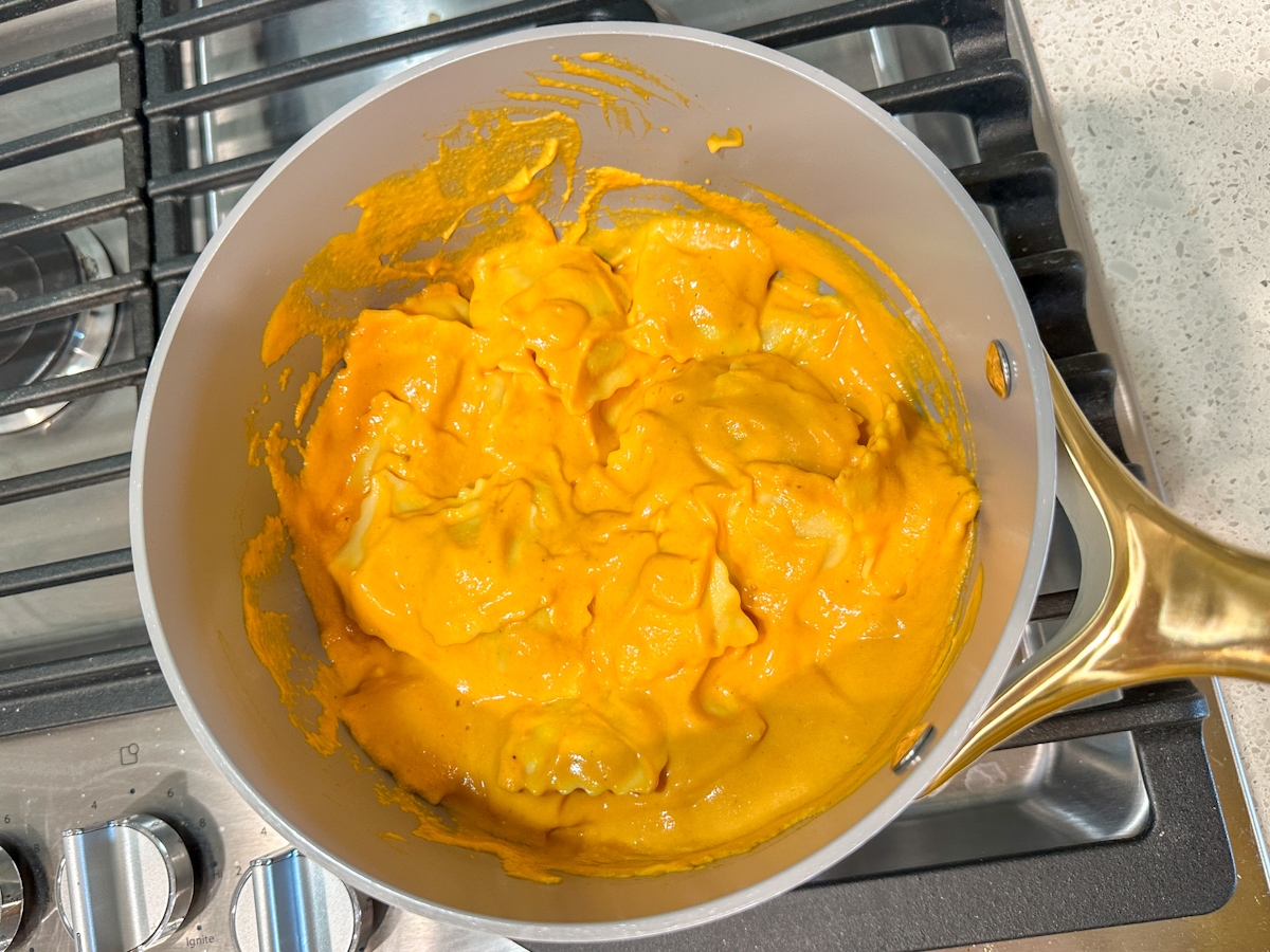 cheese ravioli with pumpkin sauce on top