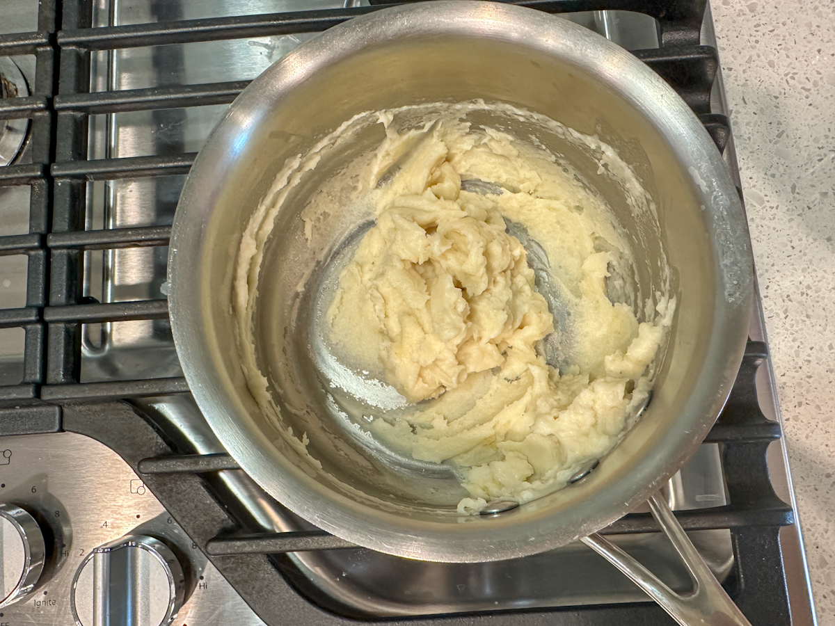 Small skillet with a creamy roux. 