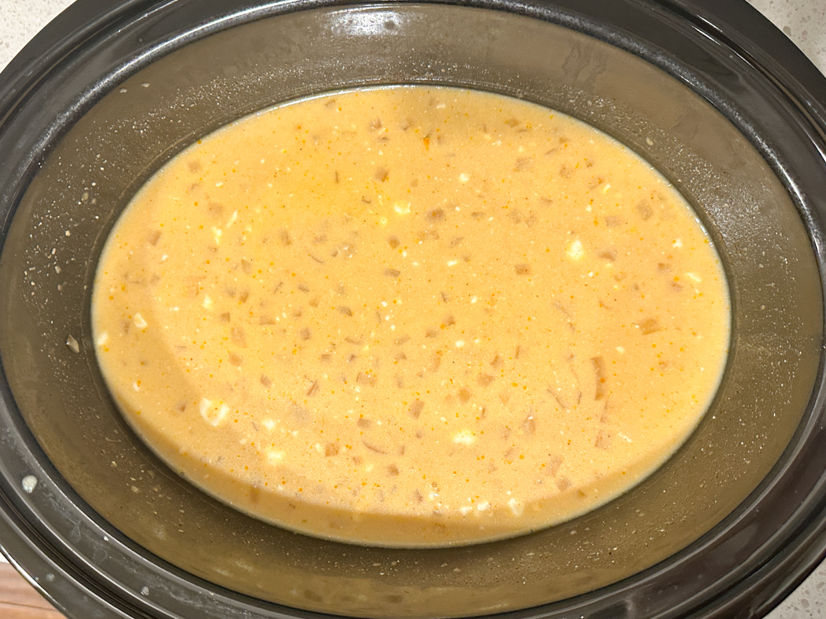 creamy chicken chili in a crockpot with chicken removed.