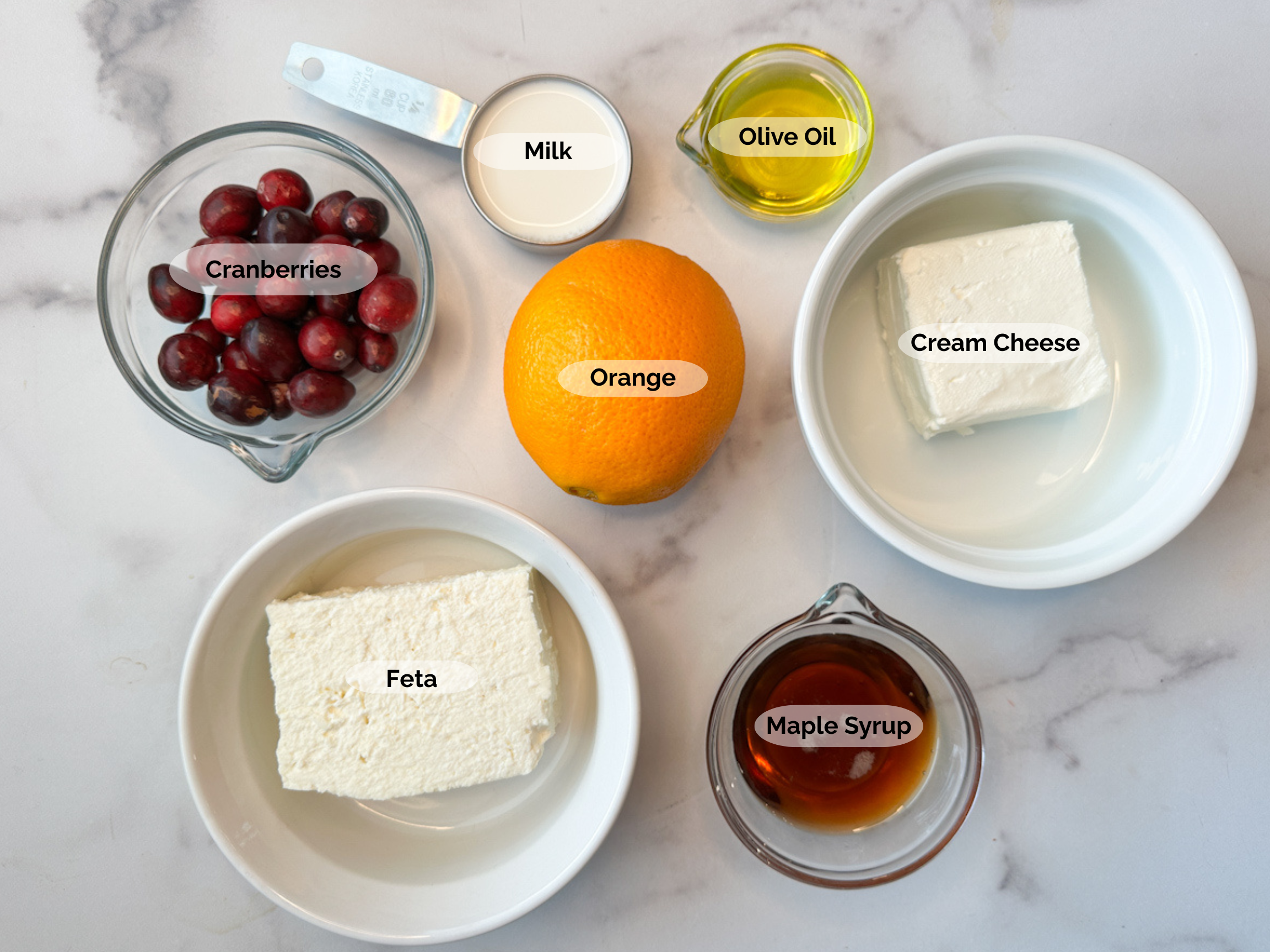 Cranberry Whipped Feta Dip ingredients: cranberries, milk, olive oil, orange, cream cheese, maple syrup, and feta.