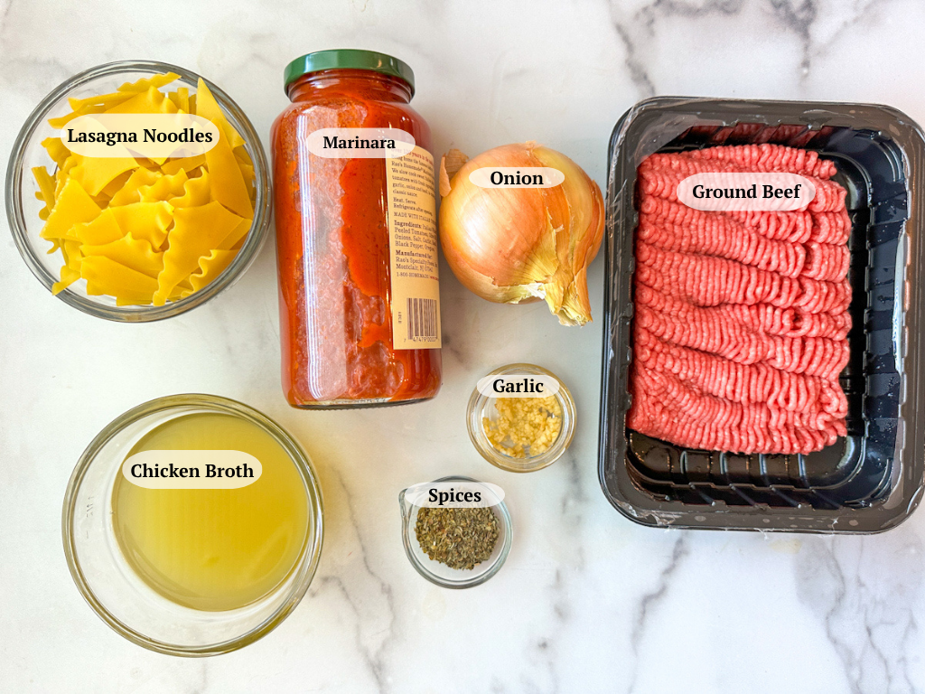 Lasagna soup ingredients: lean ground beef, jar of marinara, yellow onion, broken lasagna noodles, chicken broth, spices, and minced garlic