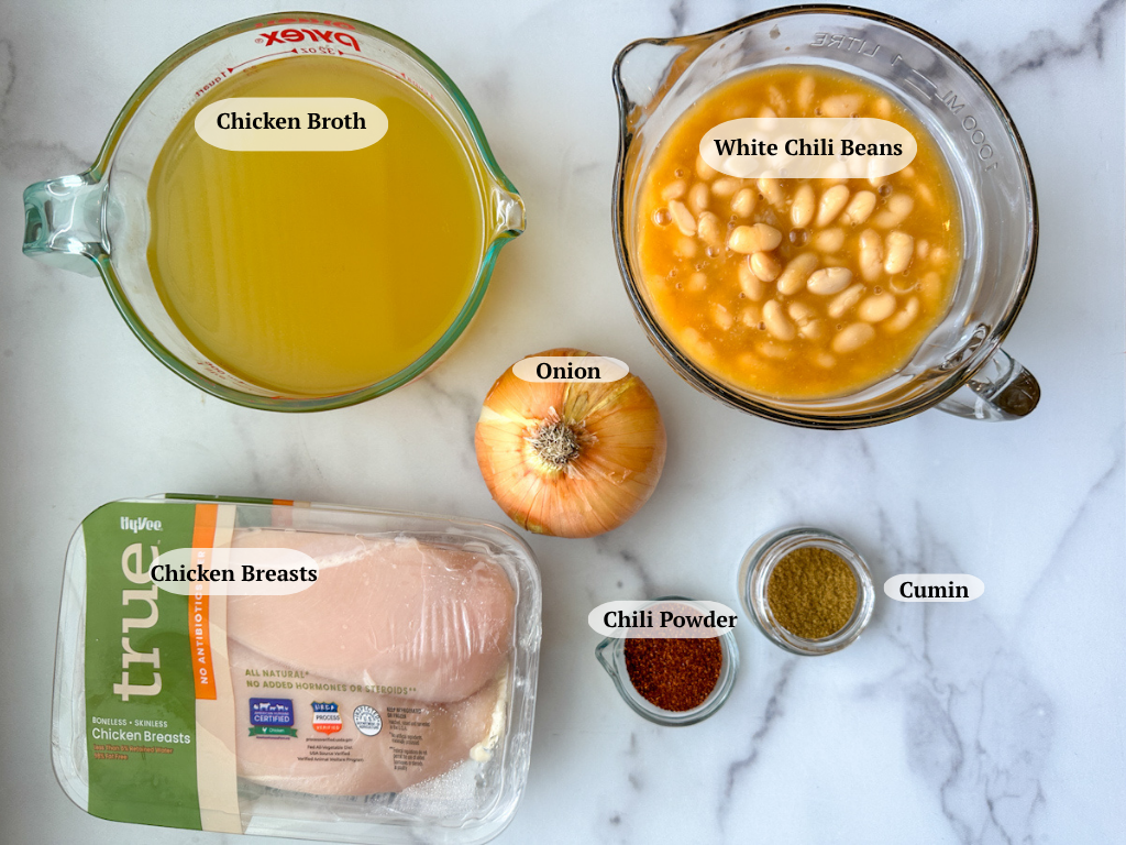 White chicken chili ingredients: chicken broth, white chili beans, onion, chicken breasts, chili powder, cumin.