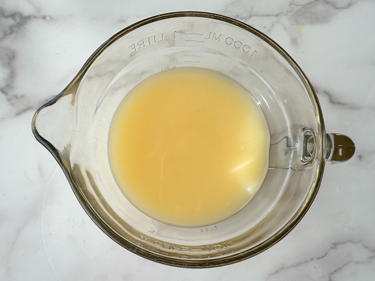 mixture of broth and egg in a large measuring cup.