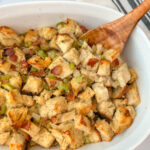 Sourdough stuffing baked in a casserole dish. Cubed pices of sourdough bread toasted with cooked bacon bits and sauteed onion and celery.