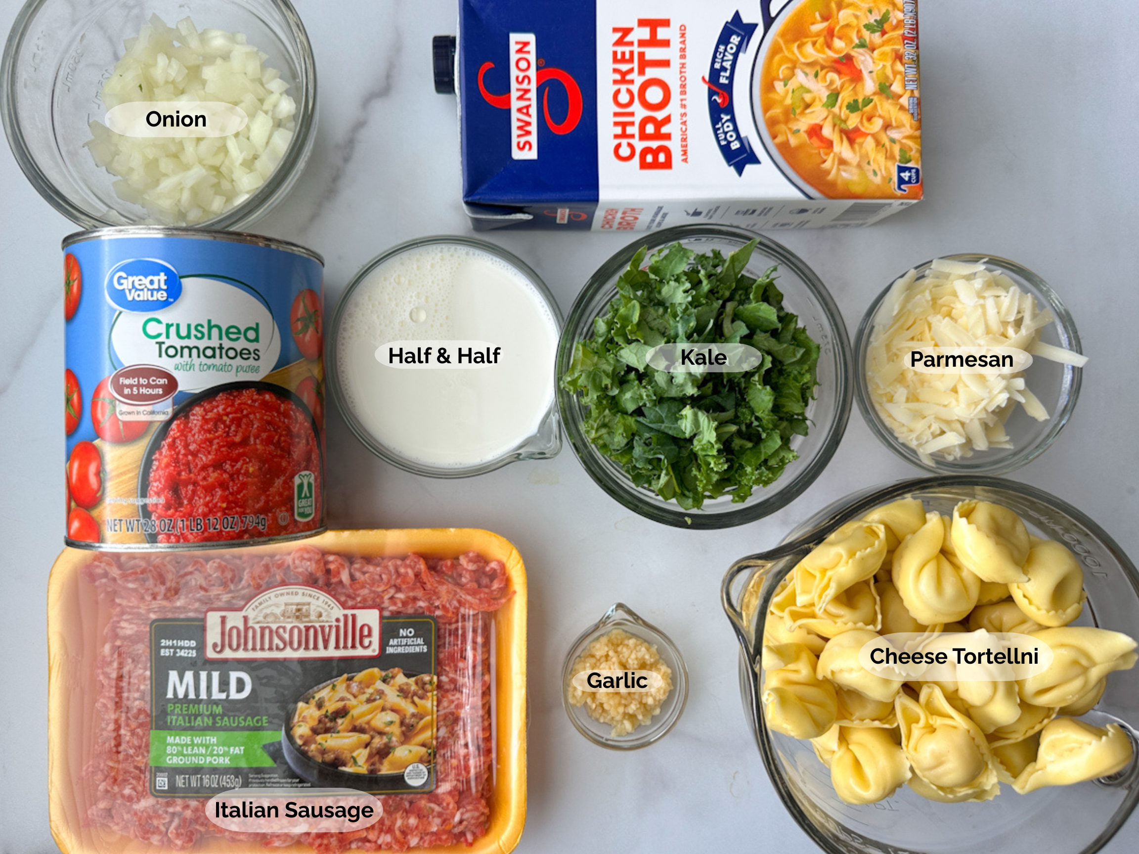 Tuscan Tortellini Soup ingredients: chopped onion, crushed tomatoes, italian sausage, chicken broth, half and half, garlic, kale, parmesan and cheese tortellini.