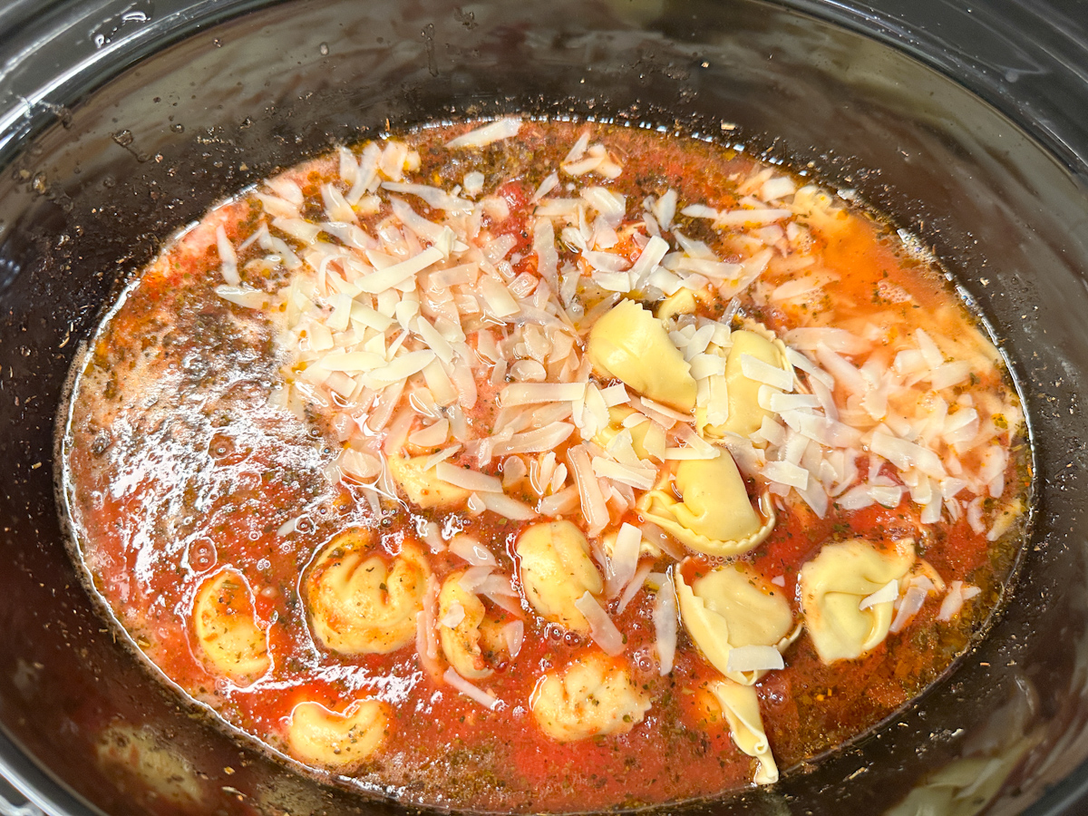 Tuscan Tortellini Soup with tortellinis in tomato soup topped with parmesan cheese, half and half.