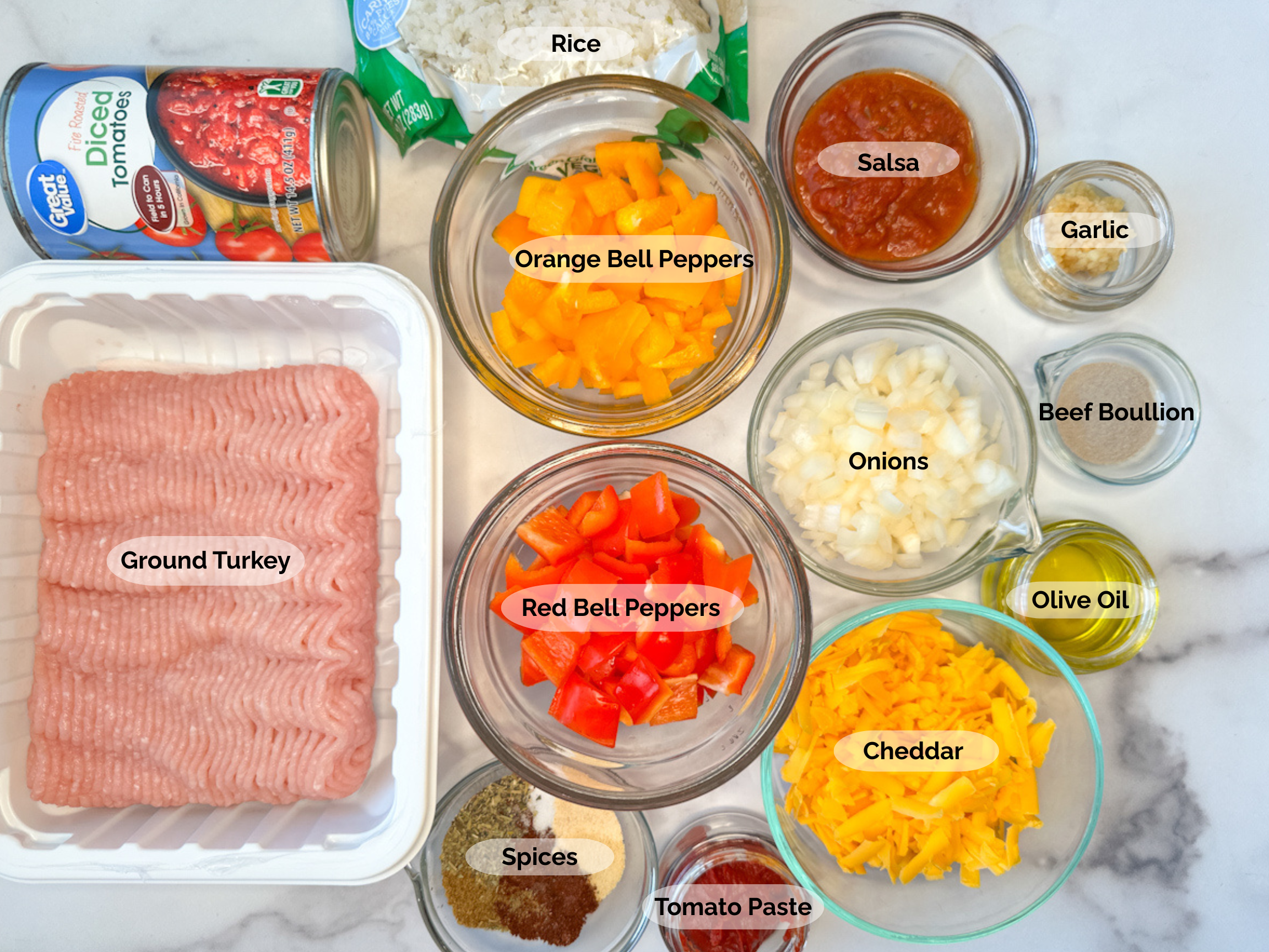Unstuffed Pepper Skillet ingredients: ground turkey, diced tomatoes, rice, chopped orange and red bell peppers, salsa, onions, garlic, beef boullion, olive oil, cheddar cheese, spices, and tomato paste.