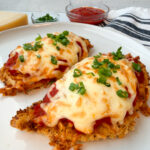 Air Fryer Chicken Parmesan: 2 breaded chicken breasts topped with marinara and melted mozzarella cheese.