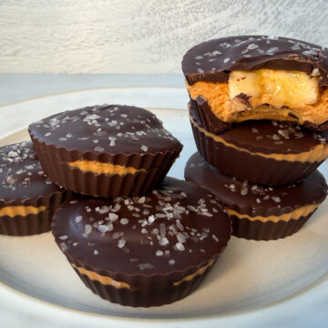 6 healthy peanut butter cups. One has a bite taken out of it.