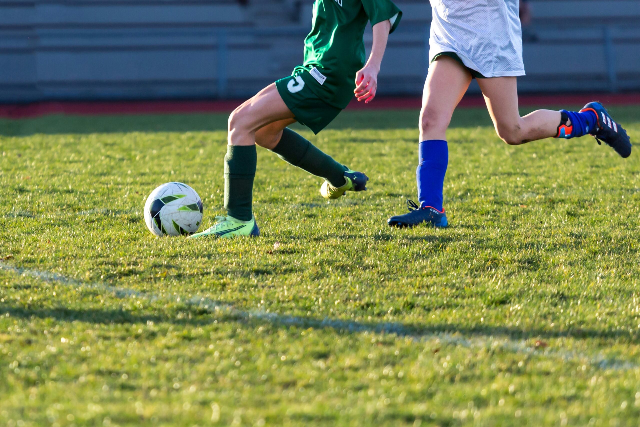 two teens playing soccer