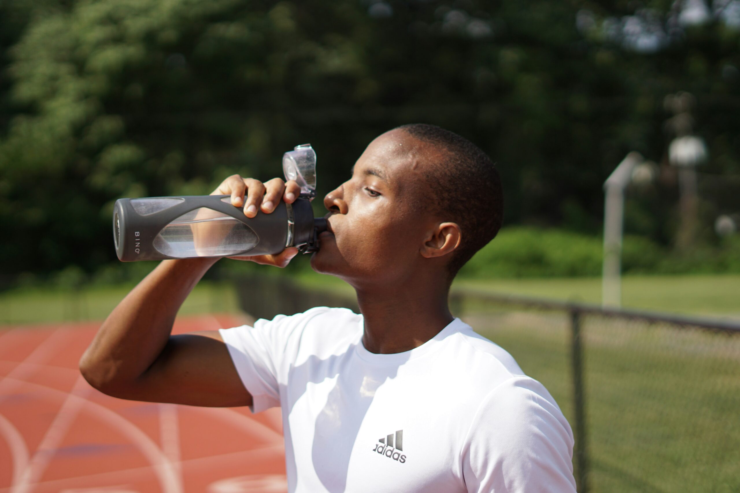 track athlete drinking water