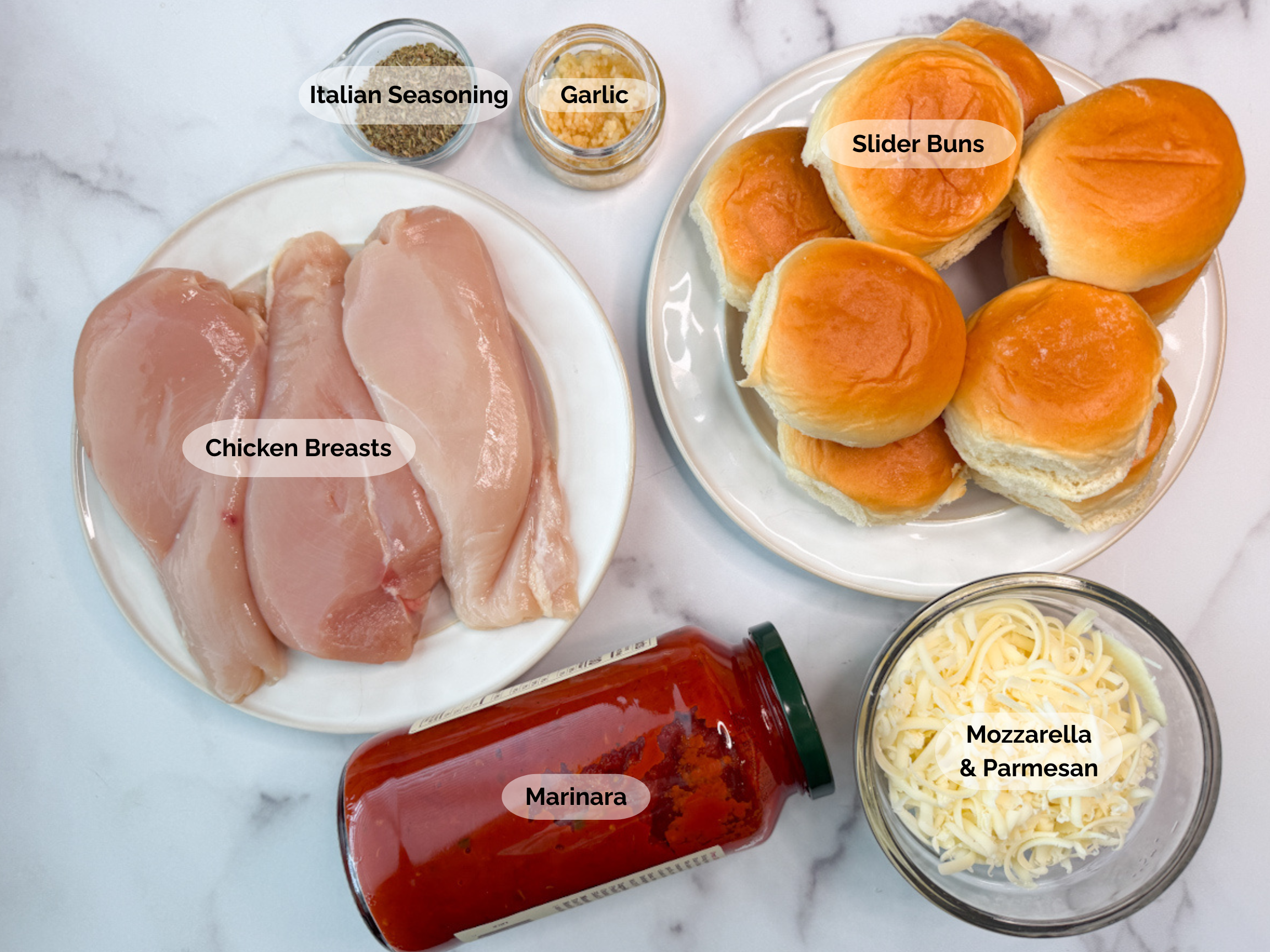 Chicken Parmesan Slider ingredients: Chicken breasts, Italian seasoning, garlic, slider buns, shredded mozzarella and parmesan, marinara.