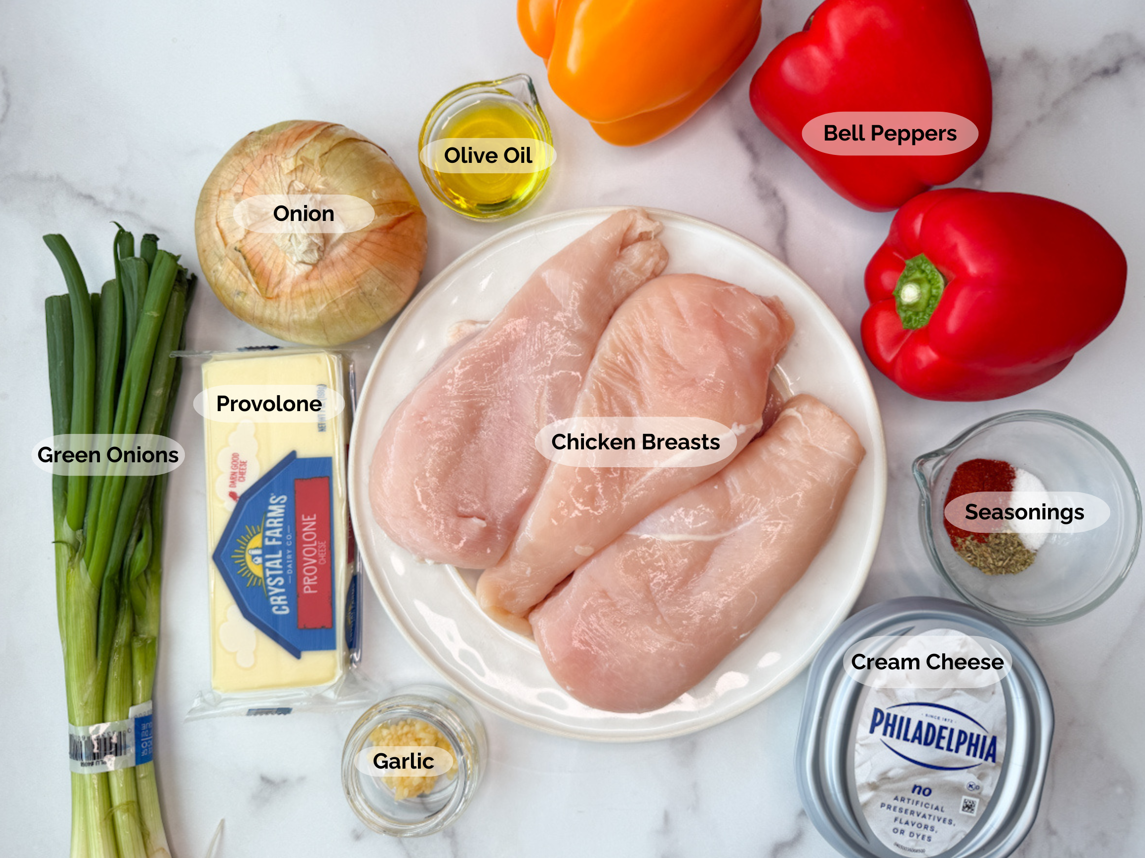 Chicken Philly Stuffed Peppers ingredients: green onions, provolone, onion, olive oil, 3 red bell peppers, seasonings, chicken breasts, garlic, and cream cheese.