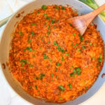 Sloppy joe orzo skillet with ground beef, tomato sauce, melted cheddar and green onions