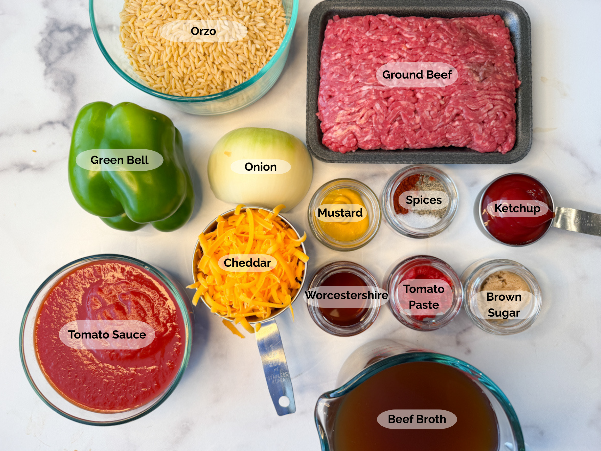 Sloppy Joe orzo skillet ingredients: orzo, ground beef, green bell pepper, onion, ketchup, spices, mustard, tomato sauce, cheddar cheese, worcestershire sauce, tomato paste, brown sugar, and beef broth.